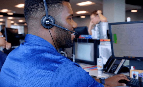 man working on the computer with headphones on